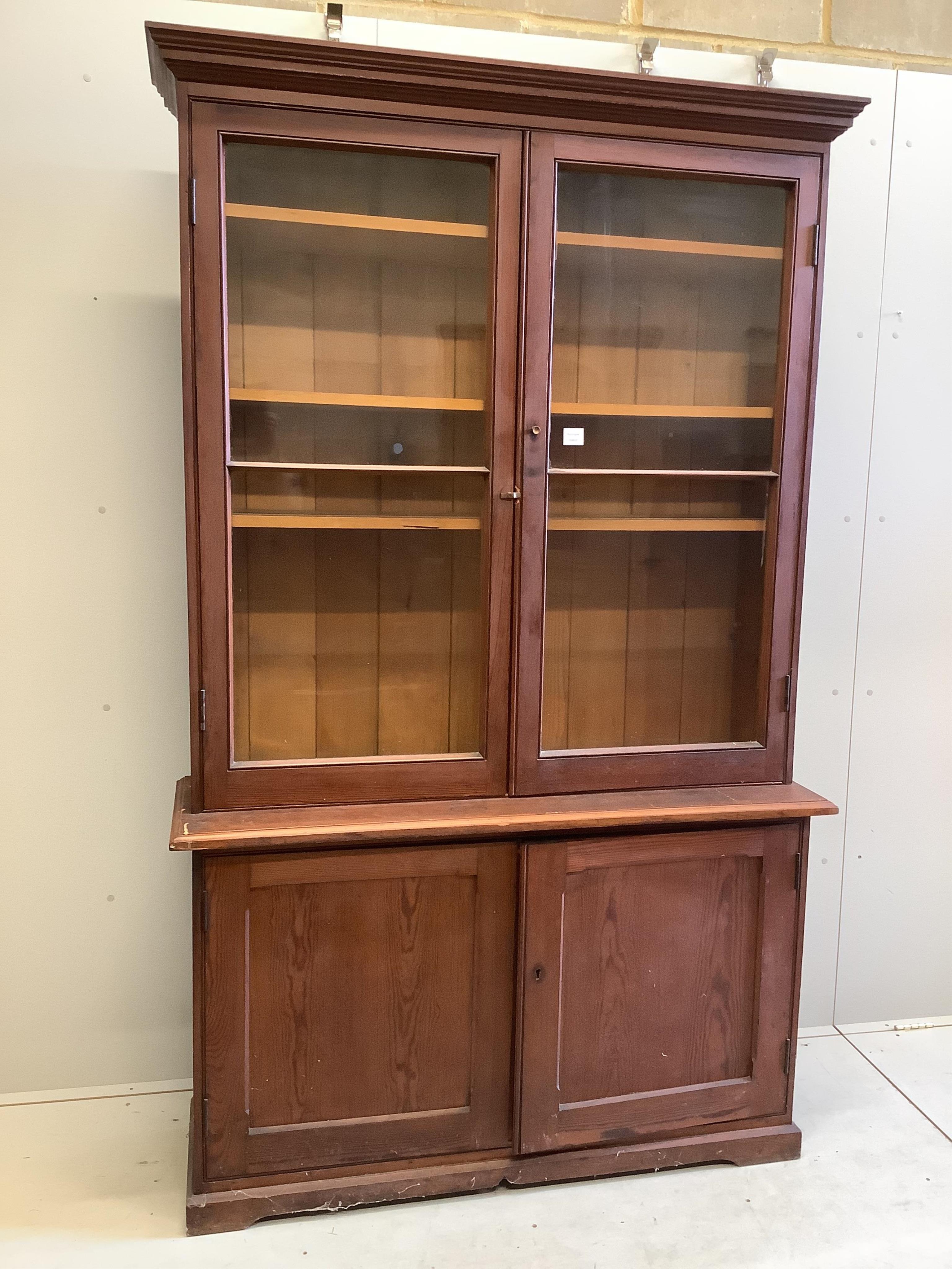 A late Victorian pine bookcase cupboard, width 130cm, depth 40cm, height 214cm. Condition - poor to fair